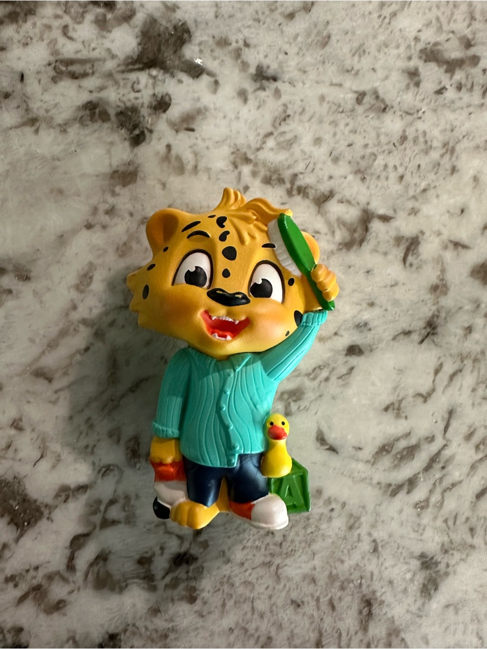 Yellow Tiger Tonies Figure with Teal Shirt and Green Brush